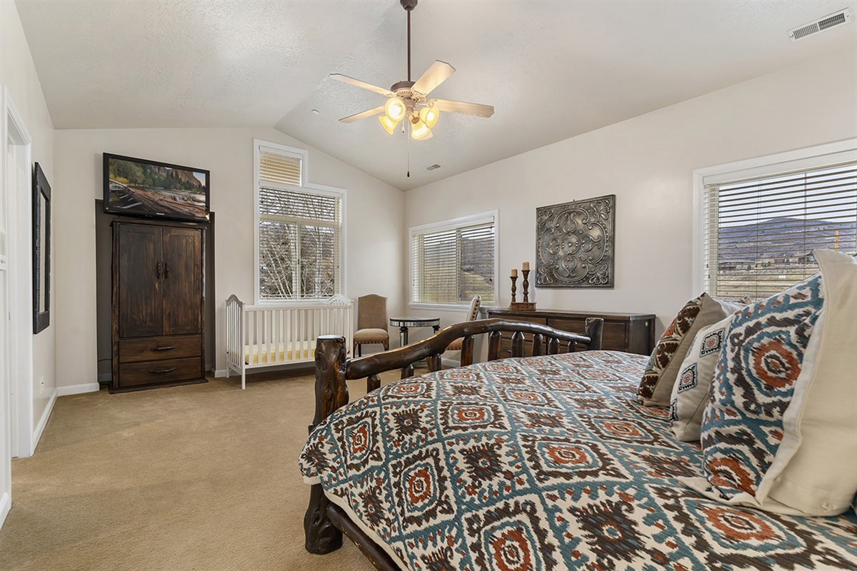 A beautifully appointed bedroom with mountain-inspired décor, offering a tranquil retreat with comfort, charm, and serene natural light.