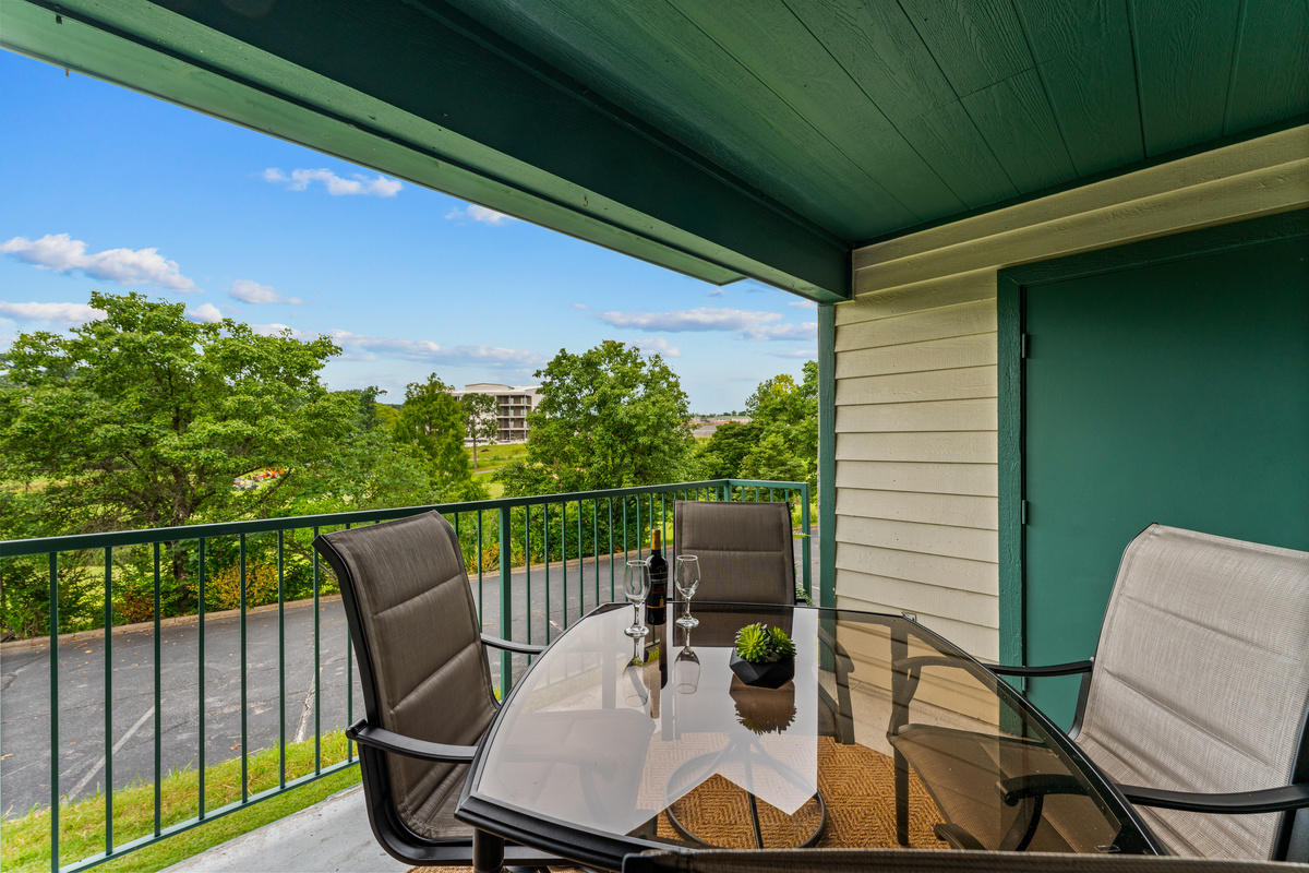 The covered balcony has room for four around the outdoor dining table and can be entered from two rooms.