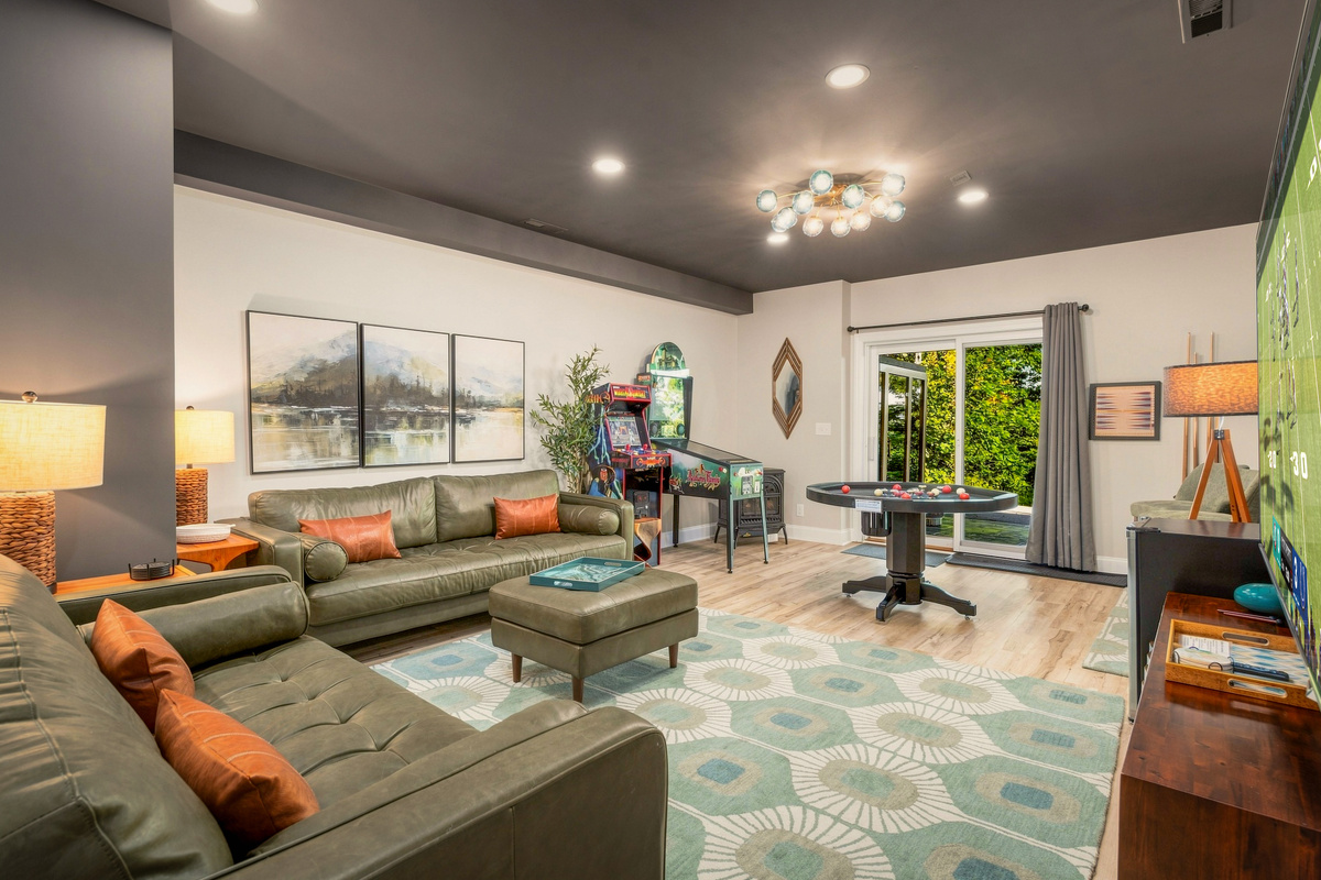 Retro arcade, combo bumper pool/poker table, and curated mid-century lounge — this game room blends fun and style for all ages
