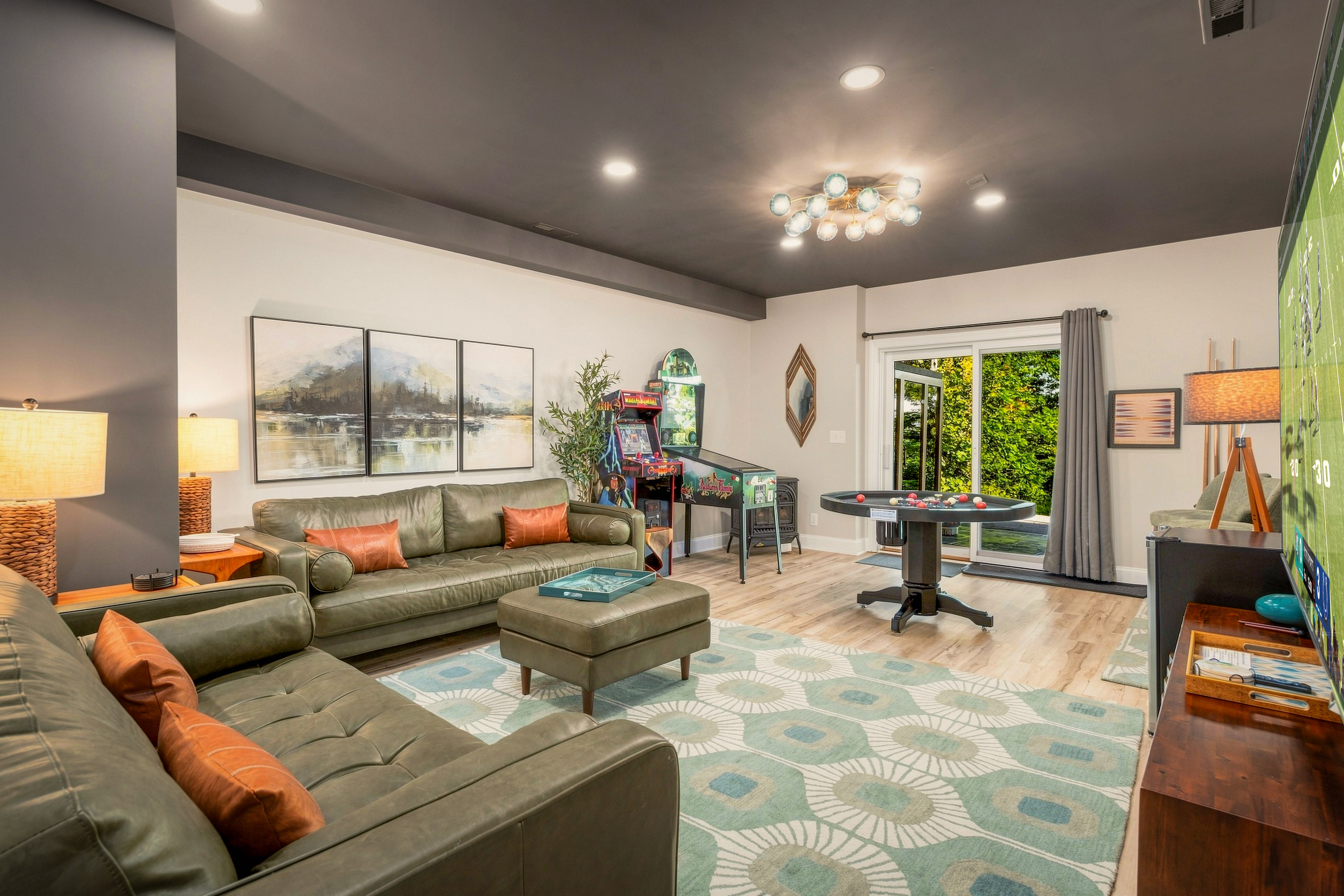 Retro arcade, combo bumper pool/poker table, and curated mid-century lounge — this game room blends fun and style for all ages