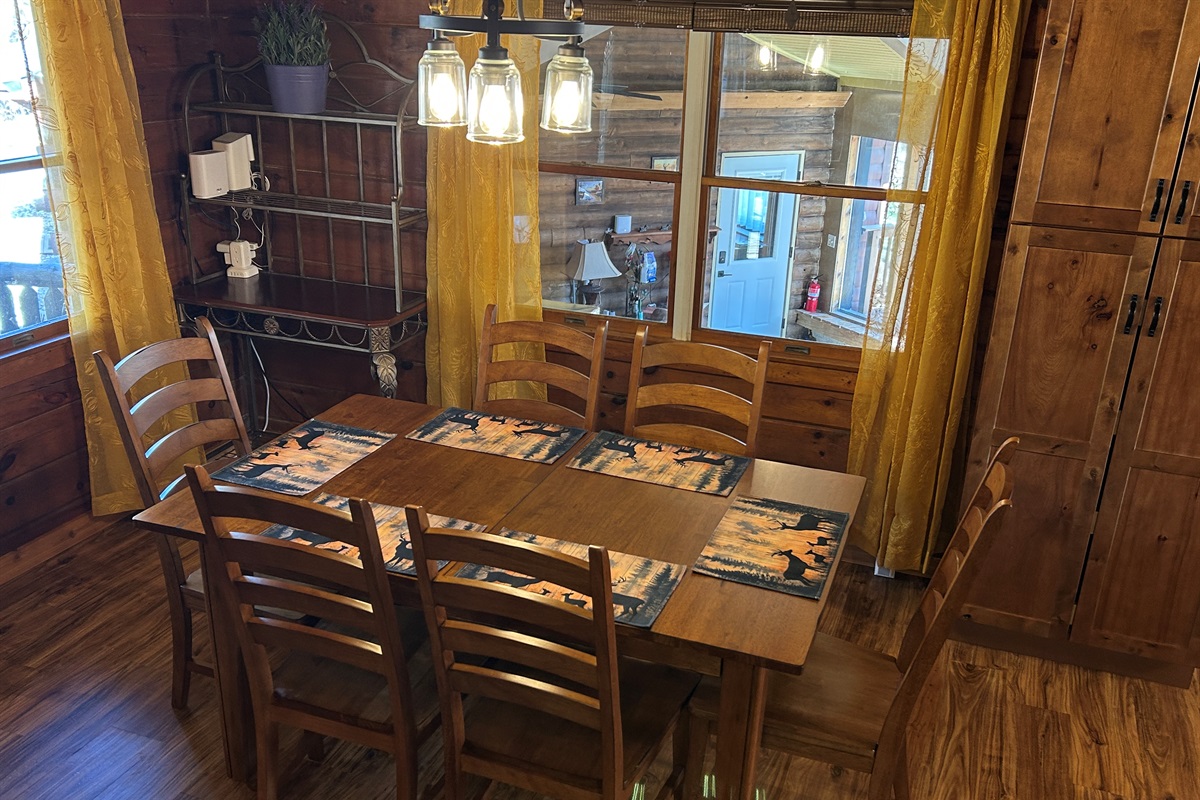 The window in the dining room overlooks the Sunroom. The pantry cabinet provides storage for your items.