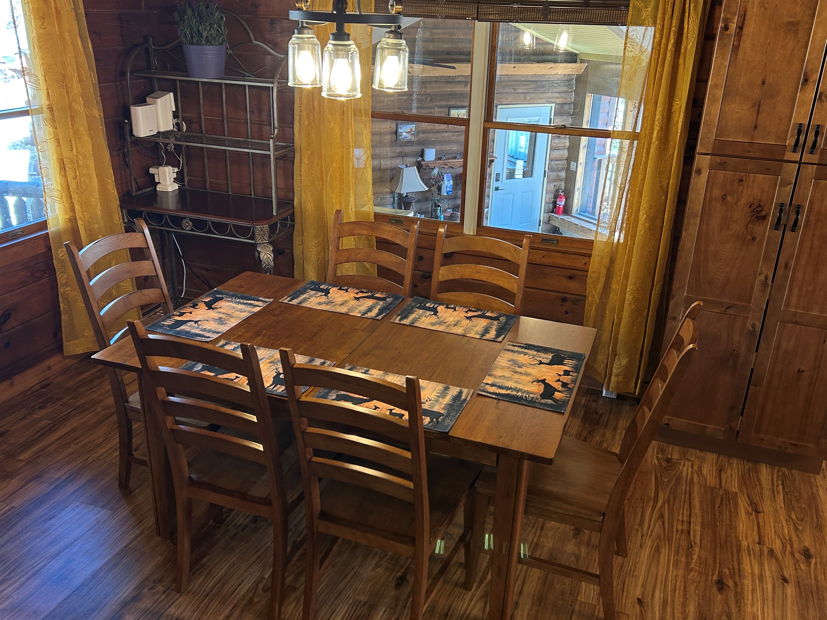 The window in the dining room overlooks the Sunroom. The pantry cabinet provides storage for your items.