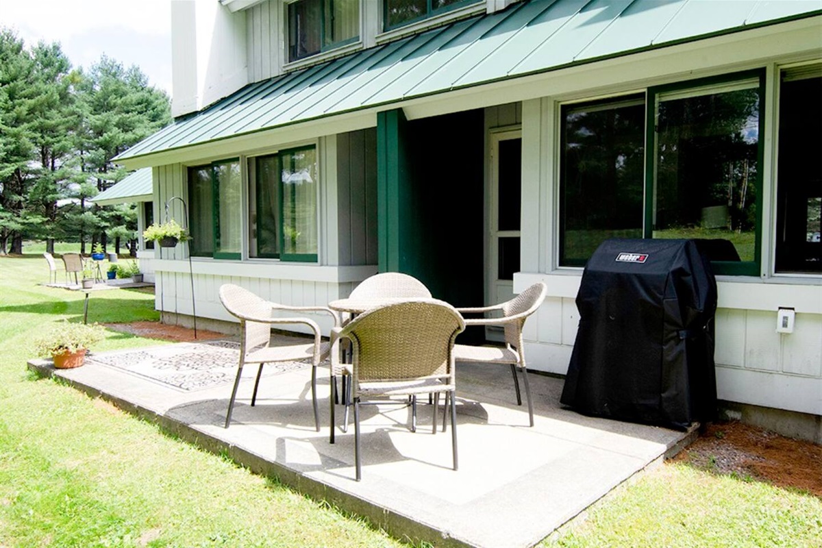 Sunlit patio for relaxing, dining, or grilling.