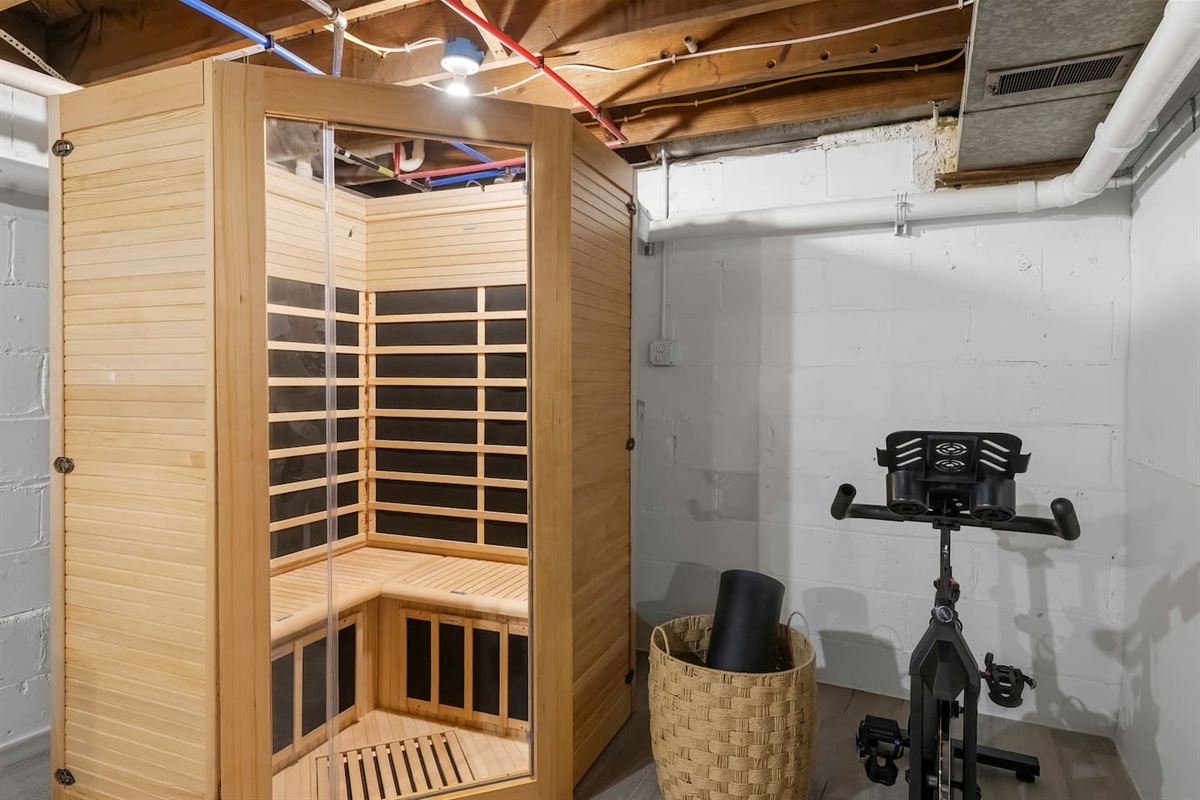 Sauna and stationary bike in the game room. 