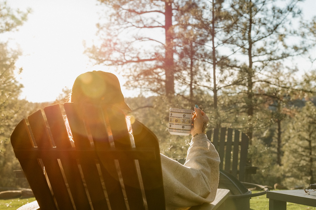 Unwind with morning coffee in an Adirondack chair at Poppywood Pines, surrounded by golden sunrise light through ponderosa pines. This tranquil Show Low cabin offers the perfect start to days exploring White Mountains hiking trails, fishing, and outdoor fu