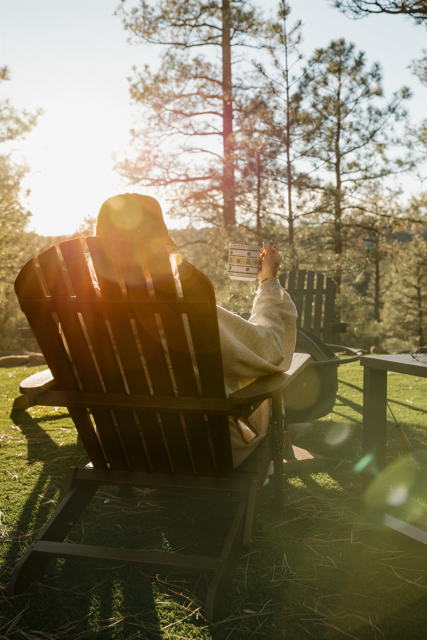 Unwind with morning coffee in an Adirondack chair at Poppywood Pines, surrounded by golden sunrise light through ponderosa pines. This tranquil Show Low cabin offers the perfect start to days exploring White Mountains hiking trails, fishing, and outdoor fu