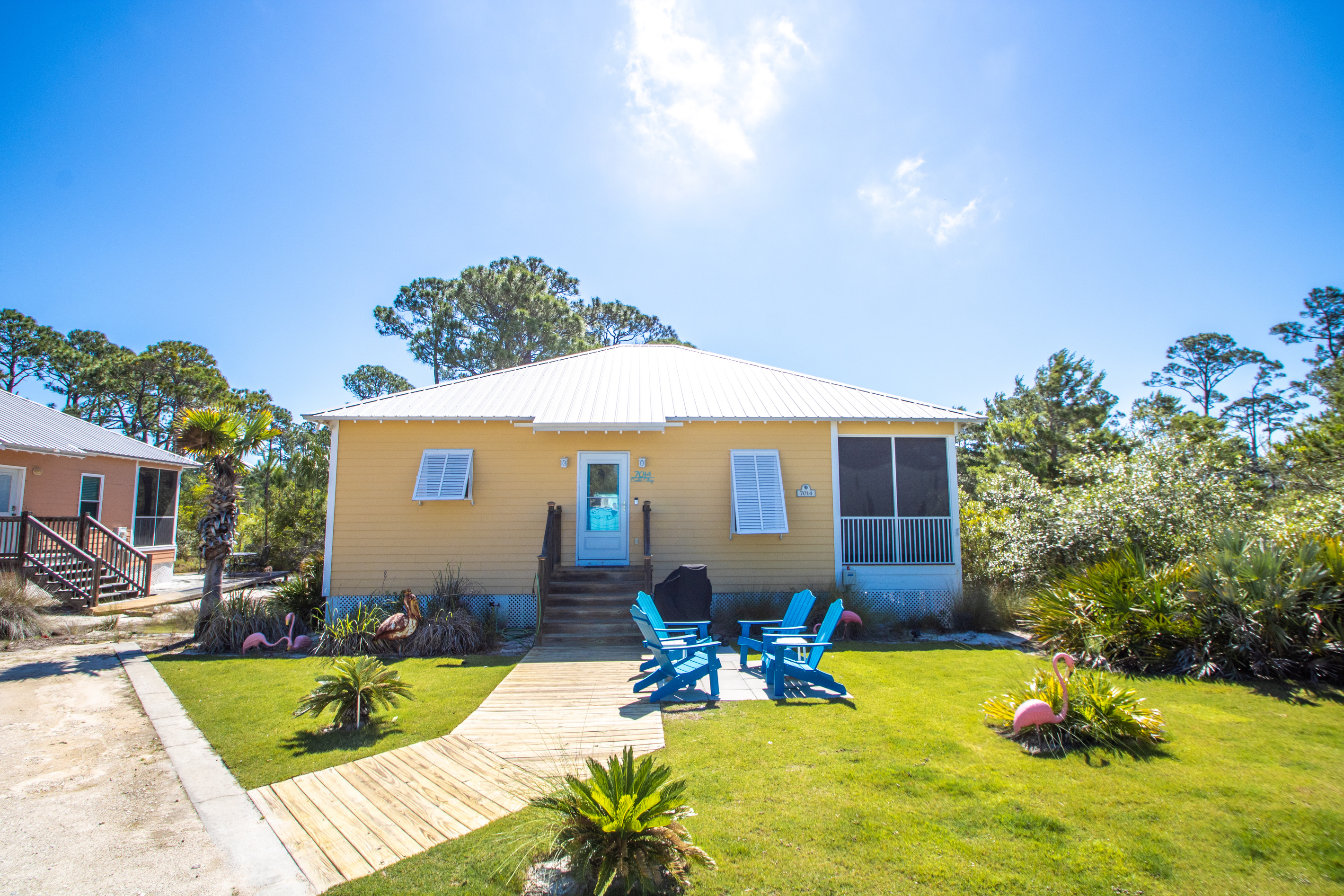 Front of Cottage, parking to the Left of wood sidewalk