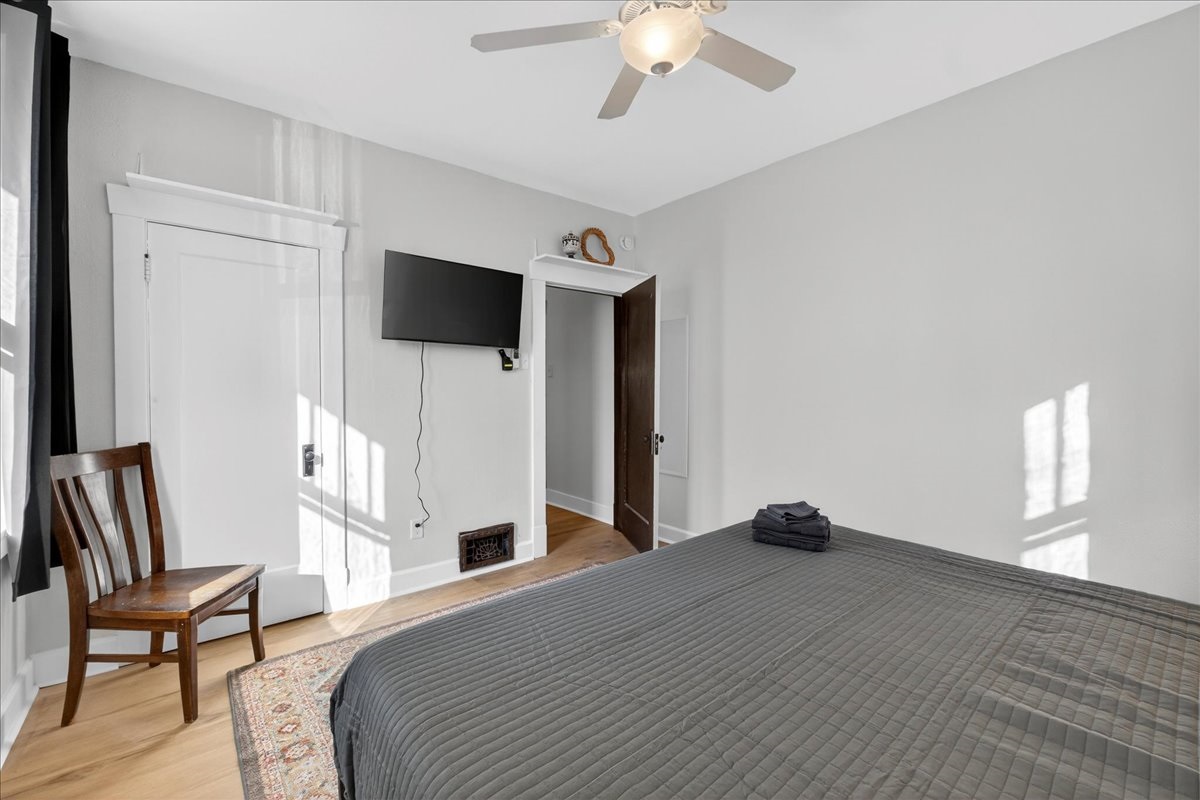 Another view of the second first-floor bedroom with a TV. 