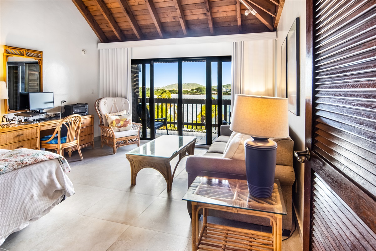 Spacious primary suite featuring an additional living space, and a private balcony with stunning ocean views. 