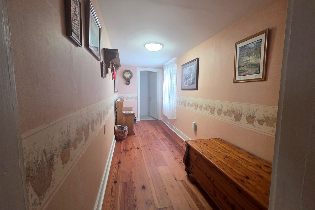 The upstairs hallway is located at the top of the steps, connecting the bedrooms and bathrooms.