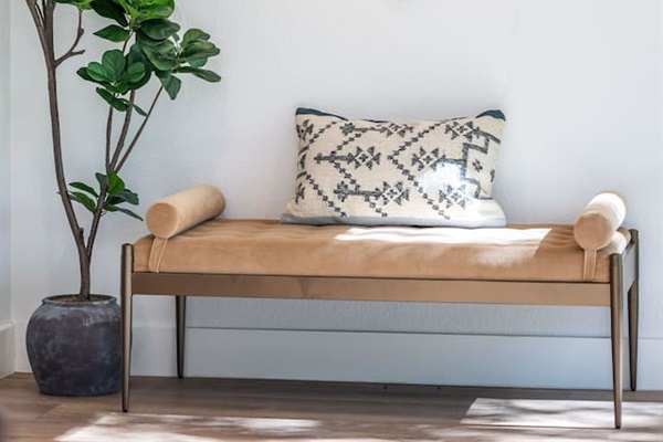 Versatile bench seating by the back door offers a convenient spot for shoes or bags and can be used as additional seating anywhere in the home.