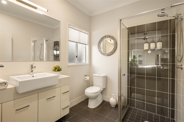 Private ensuite with shower, and modern finishes.
