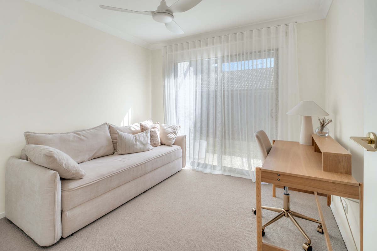 A versatile retreat with a comfortable lounge and dedicated workspace, perfect for relaxing or catching up on work.