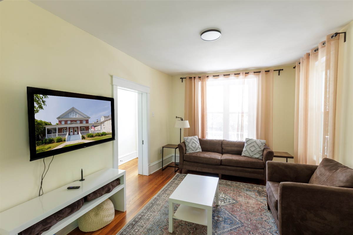 Living room with comfortable seating and a Smart TV.