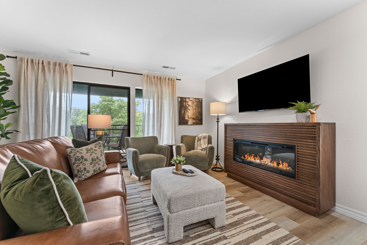 Gather around the electric fireplace in the bright living room. The 65-inch Roku TV includes cable, and the leather sofa opens into a bed for guests 5 and 6.
