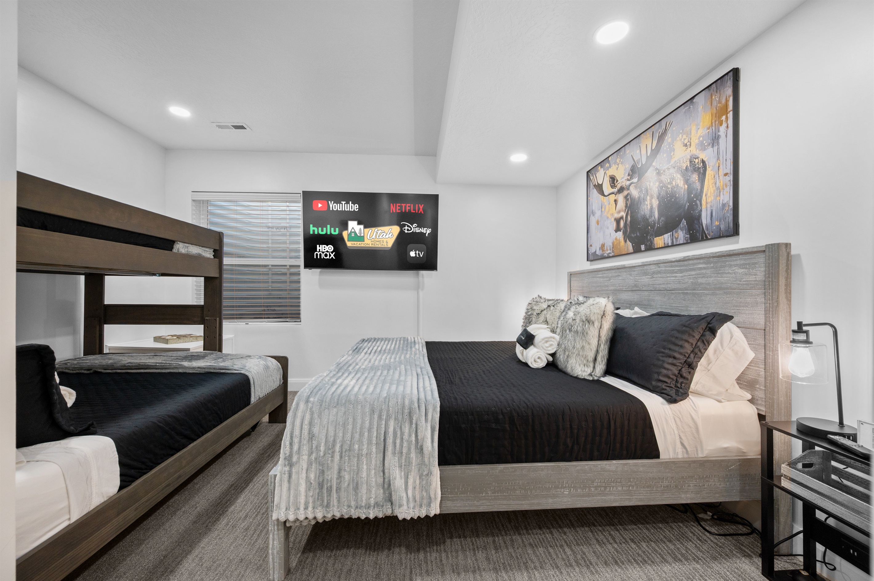 Spacious lower-level bedroom featuring a twin-over-queen bunk.