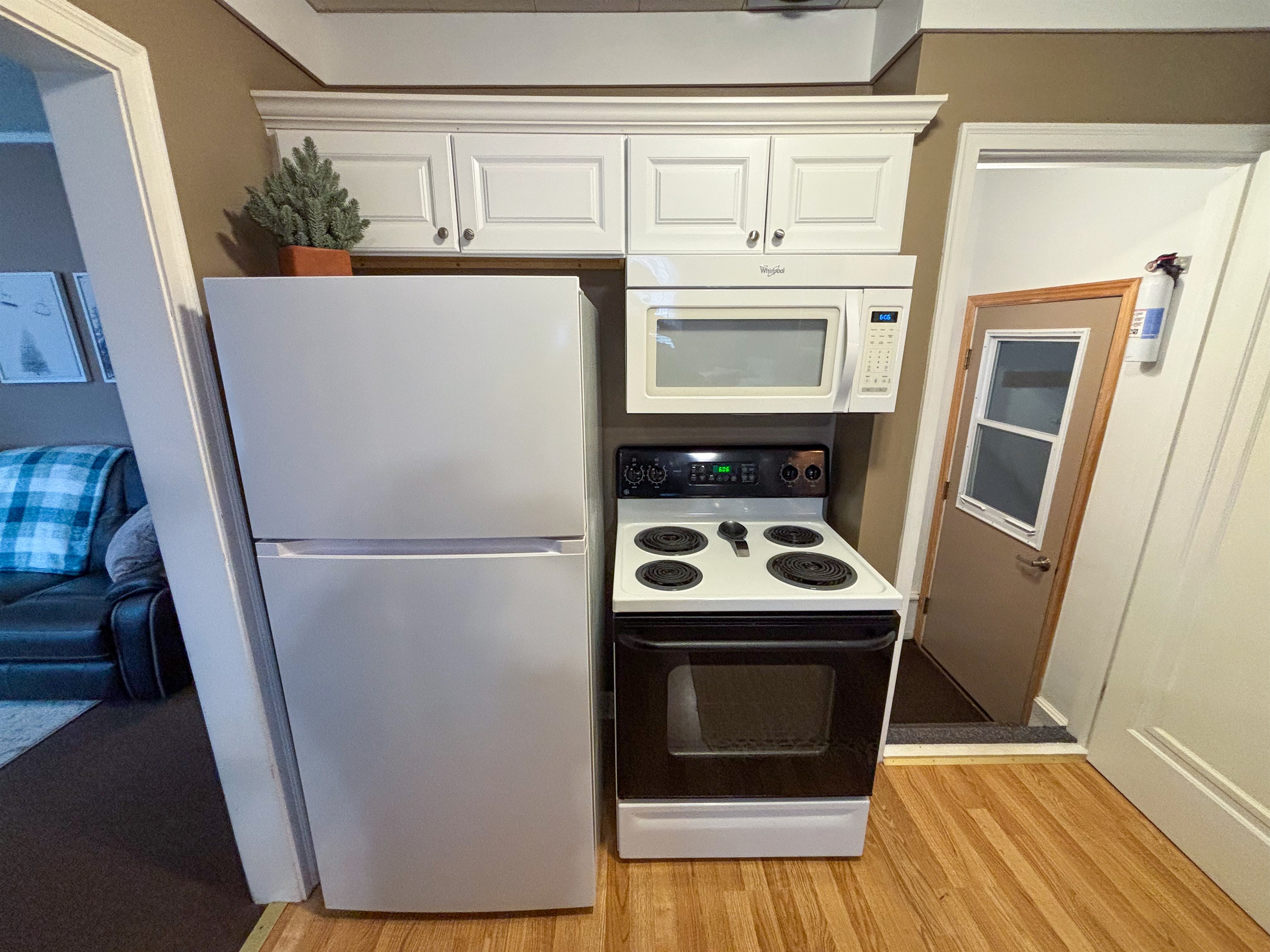 Modern and efficient—everything you need to create a delicious meal. The kitchen features a stainless steel refrigerator, stove, coffee maker, kitchenette oven, kettle, and blender