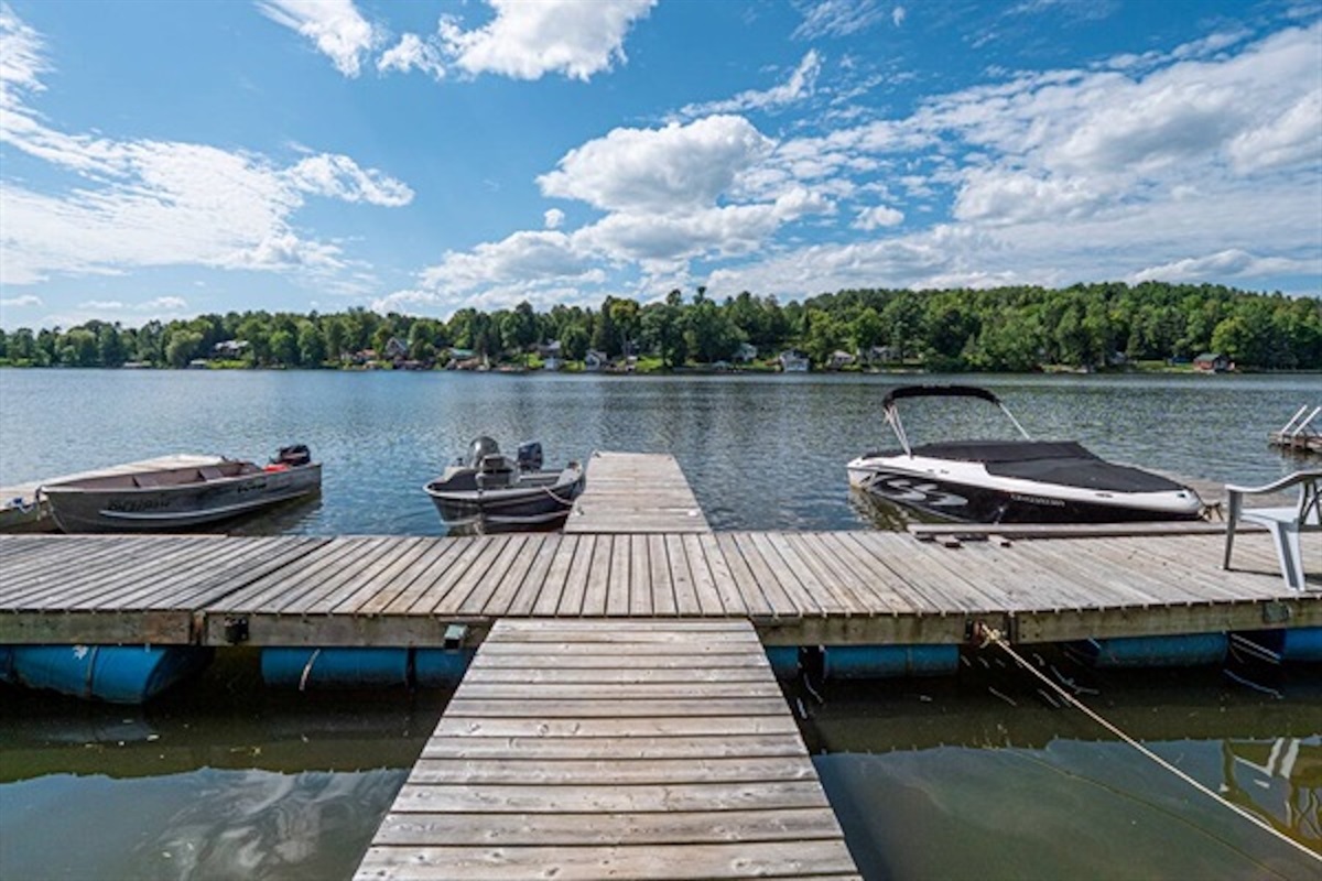 Dock extending onto the waterfront with boats nearby
