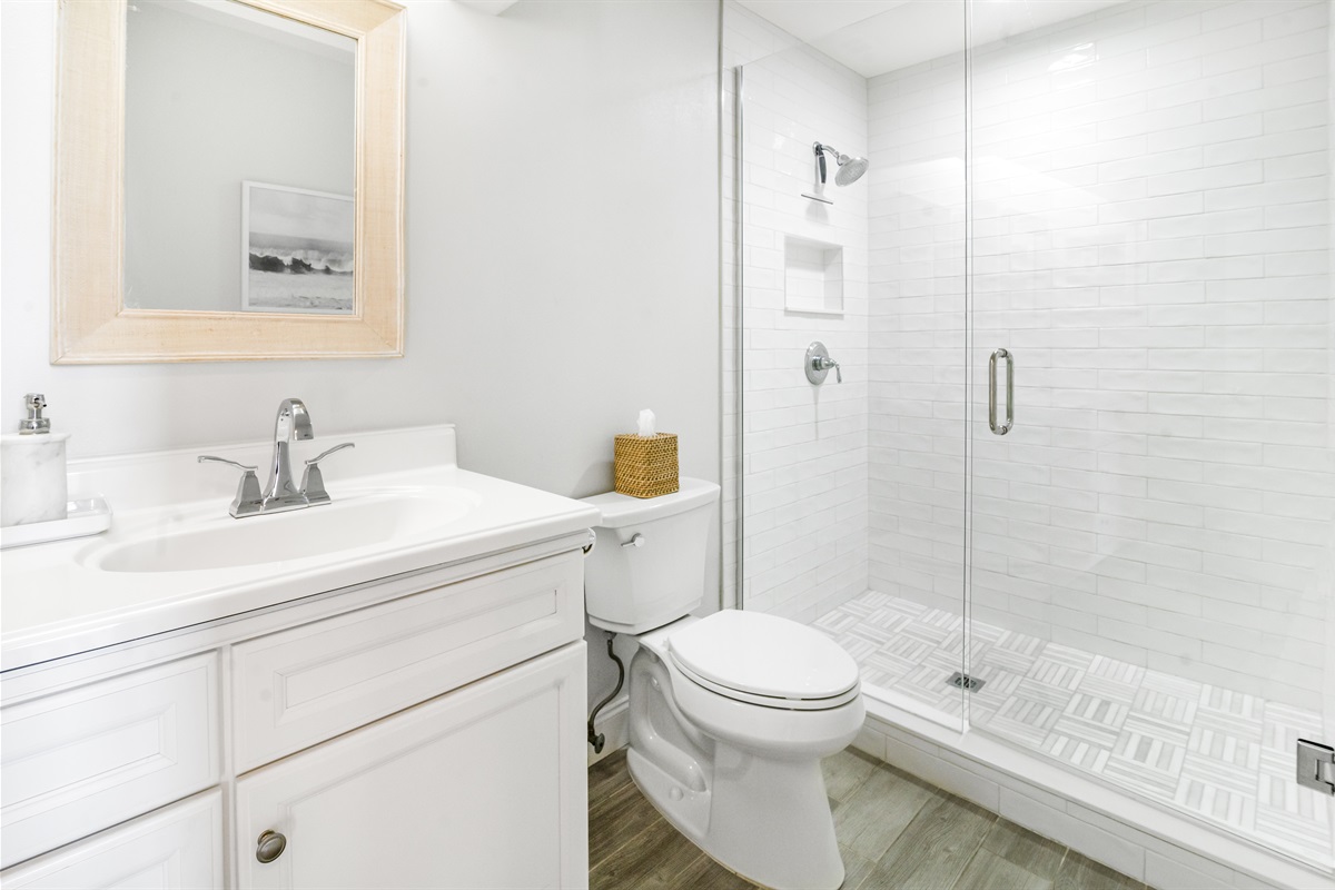 Attached to the main bedroom, this en-suite bathroom offers a clean, spacious layout with fresh towels and thoughtful touches.