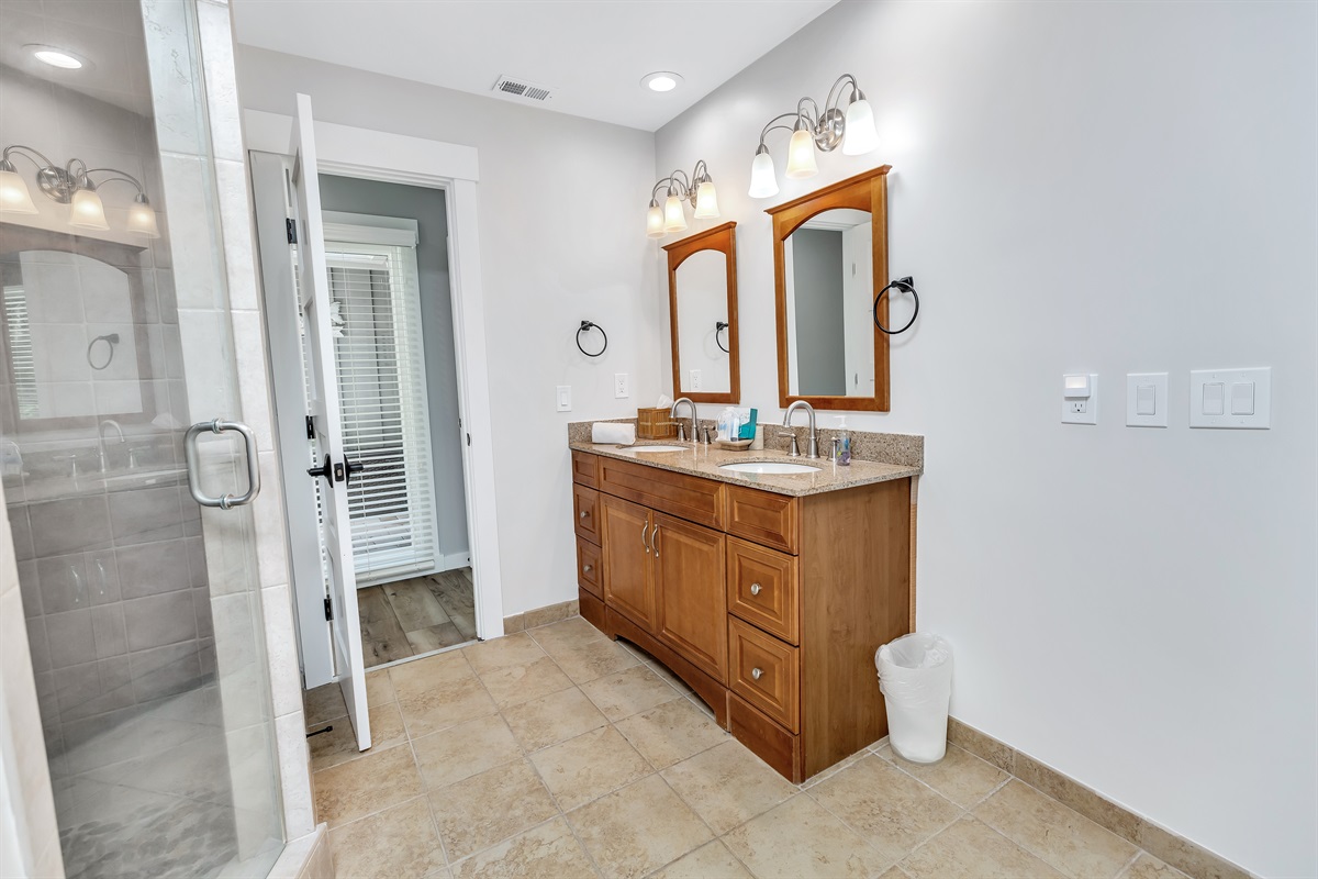 Master bath features double sink vanity and private shower