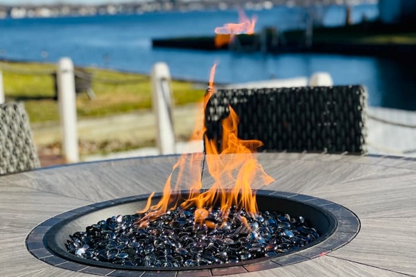 Outdoor table with a fire pit perfet for gathering under the stars.