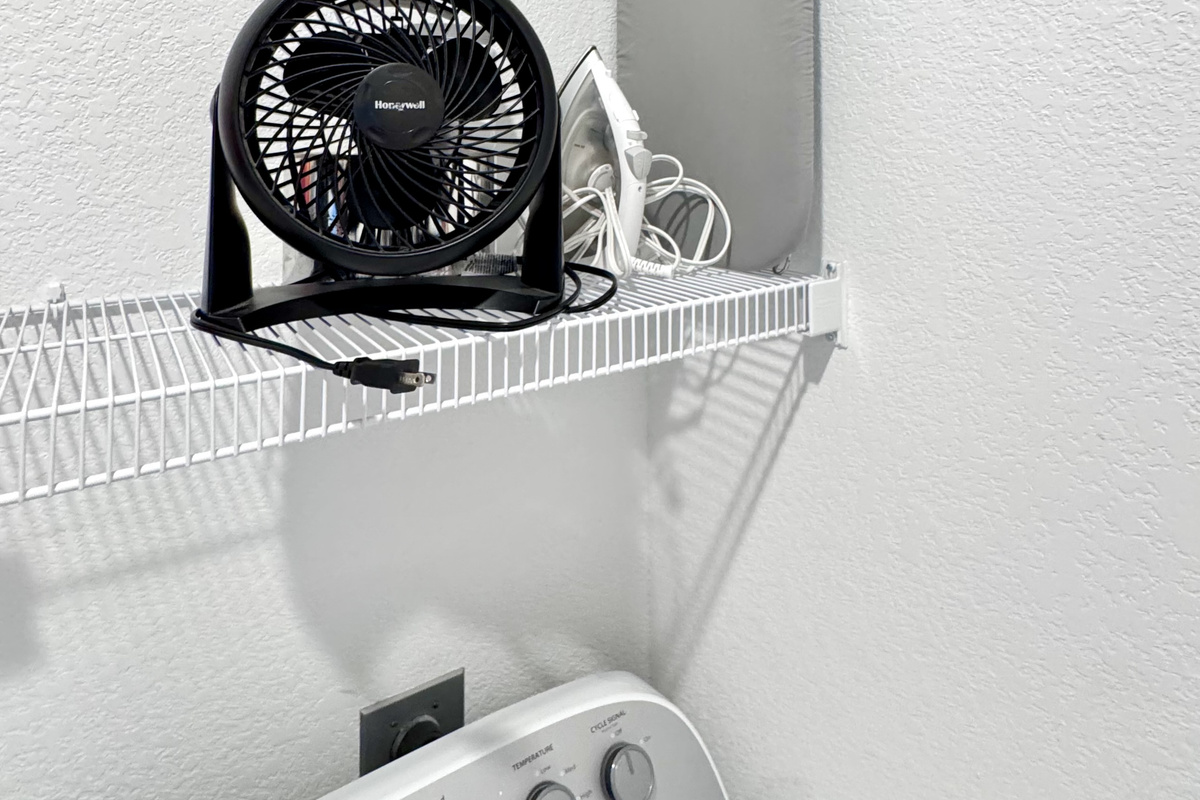 Ironing board, iron, and extra nightstand fan