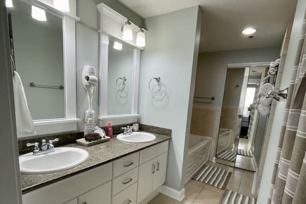 Master bath with tub, shower, and double sink vanity