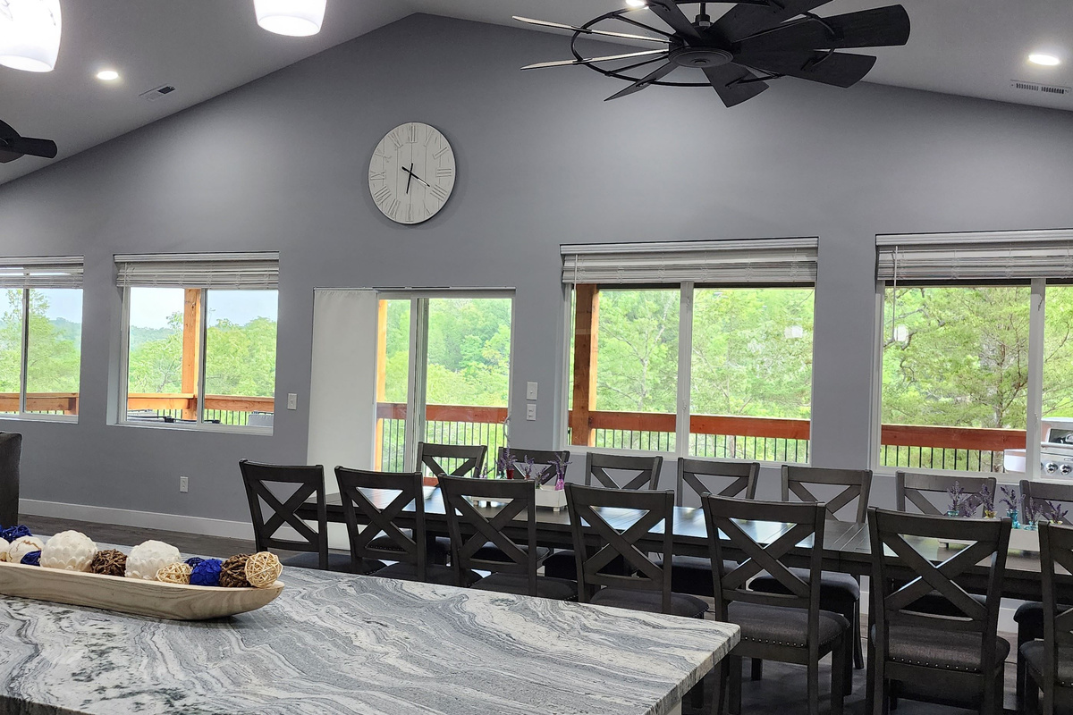 Spacious dining and gathering space with beautiful wooded views.