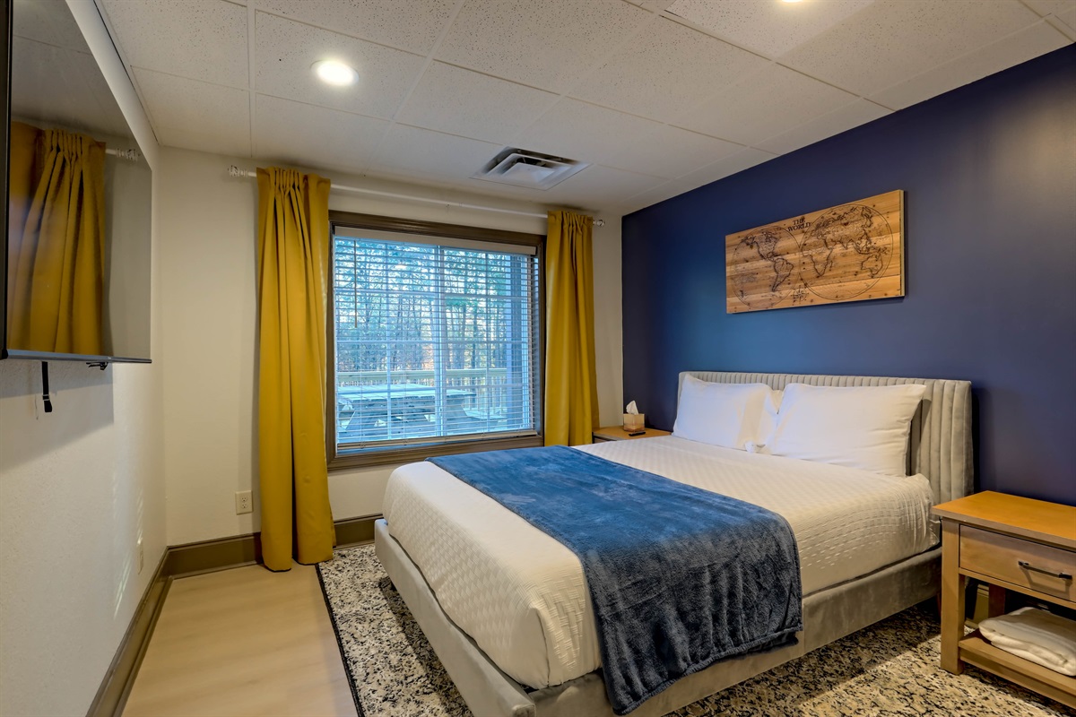 Cozy queen bedroom with plenty of natural light