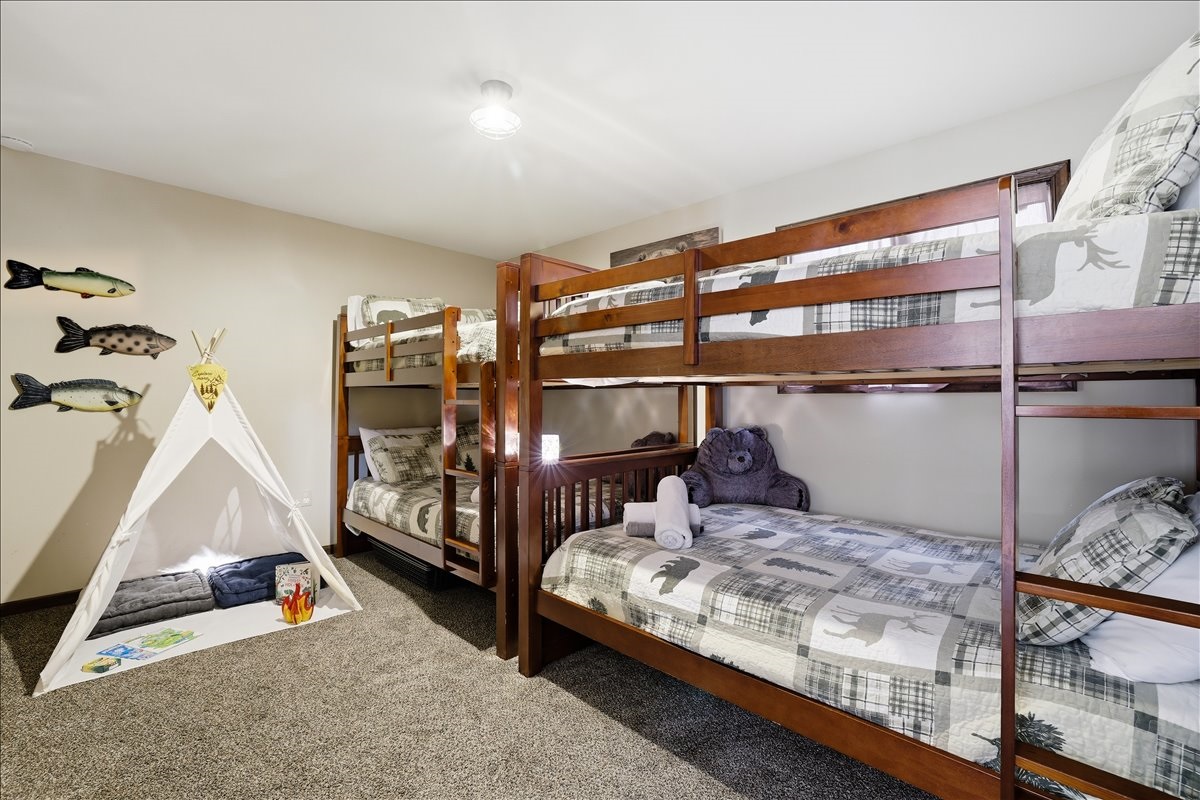 Sleeping four across two sets of full bunk beds, the kids' room is equal parts cozy and fun (with a secret surprise inside)