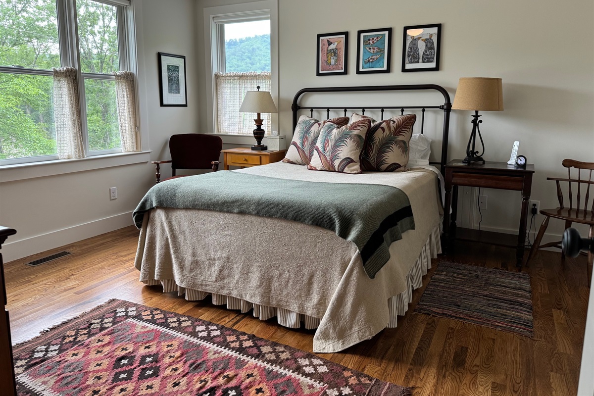 The upstairs queen bedroom bathed in natural light.