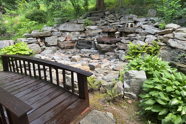 Side View of Japanese Bridge over waterfall.