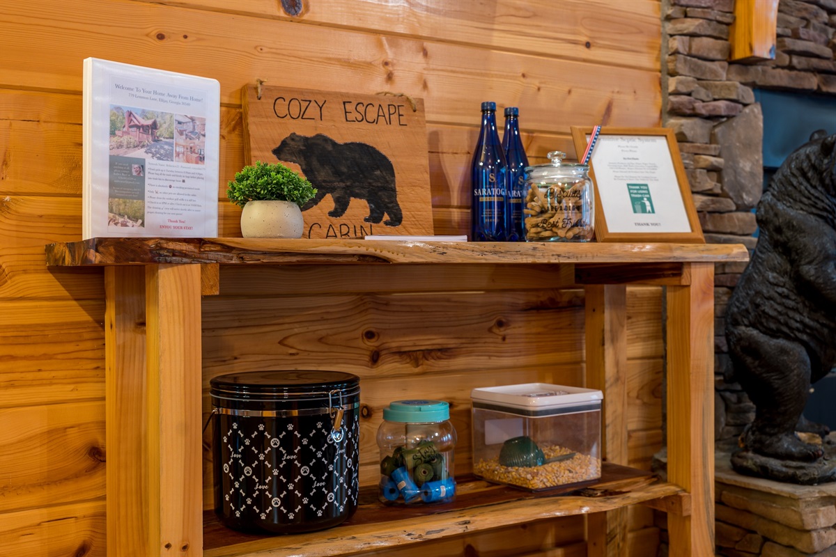 Welcome table with cabin booklet, house rules, neighborhood information, 2 resort amenity passes (one each for 4 adults/day), guest book and of course, doggy treats, dog food container and essentials.