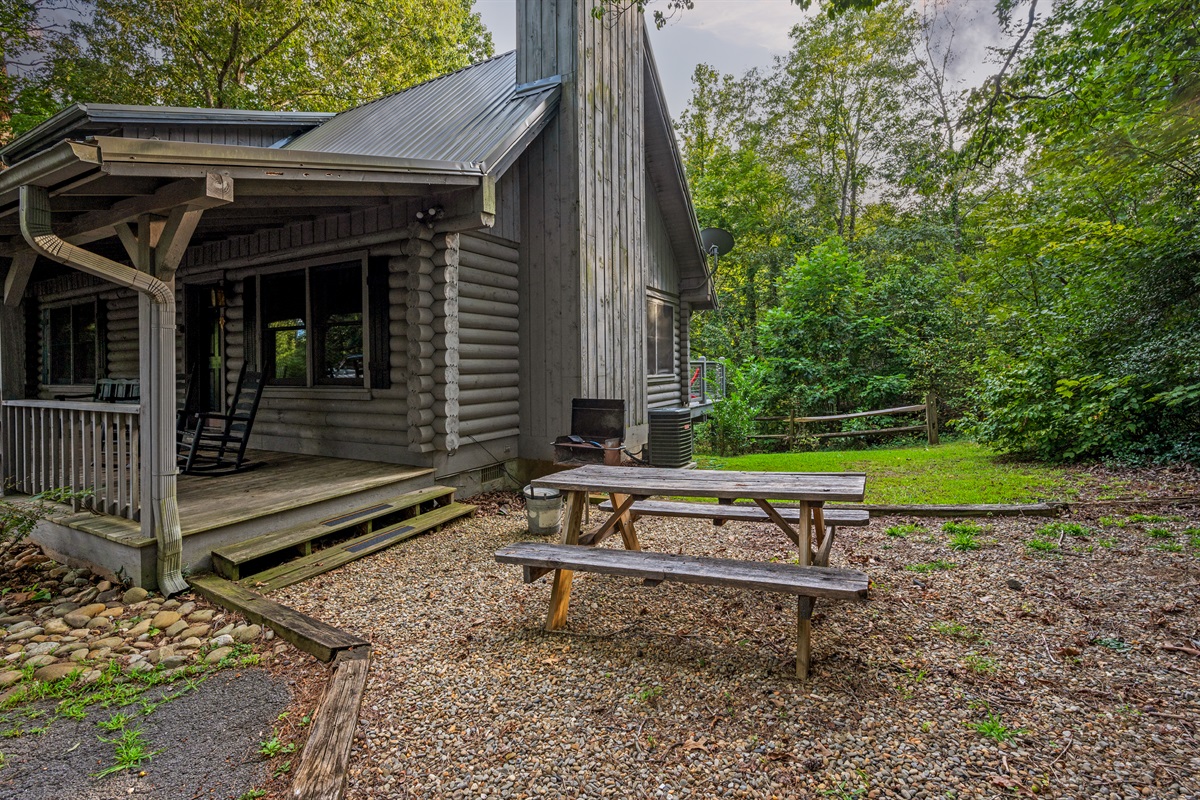 Relax on the porch or enjoy outdoor dining at your cozy log cabin retreat.