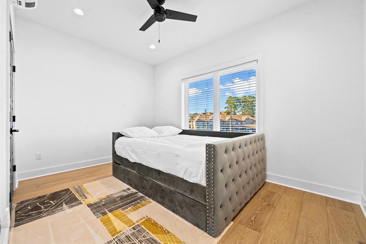 This queen bedroom offers a cozy and contemporary retreat, with soft light, thoughtful decor, and a spacious layout perfect for unwinding.
