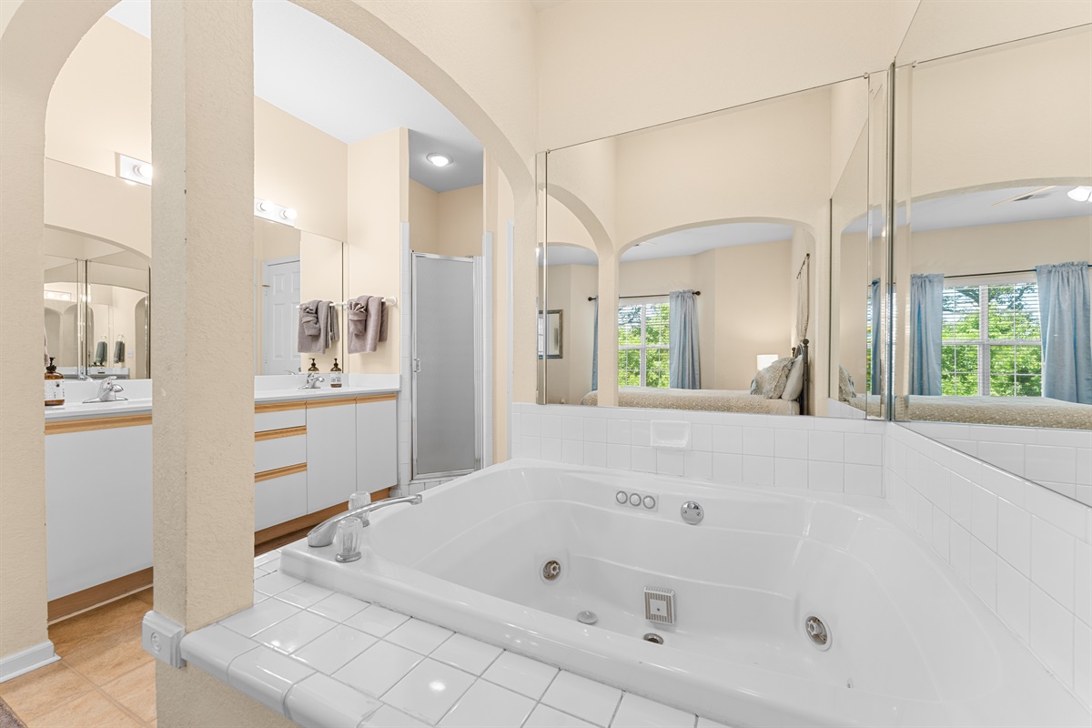 Oversized soaking tub in the primary bath offers extra room to unwind at the end of the day.