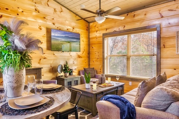 Welcome to MistyOak Cabin! Unwind in the cozy living room with comfy seating, soft throws, and mountain views. Perfect after a day of exploring the Smoky Mountains.
