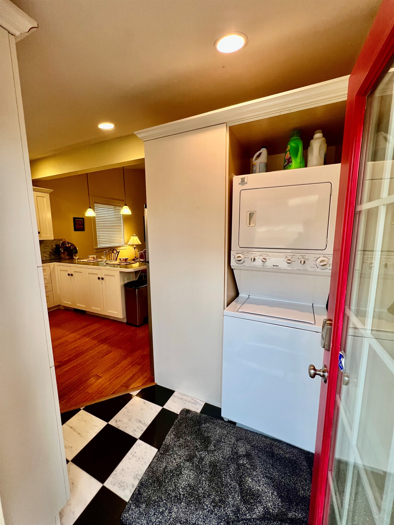 Enjoy the convenience of an in-unit, stacked washer and dryer, located just off the rustic dining area and open-plan living room.