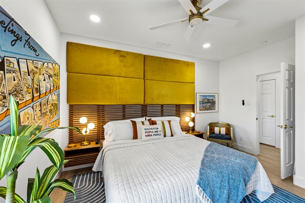 Enjoy comfortable bedding and space to relax in the Vintage Galveston Suite.