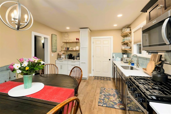 Just off the kitchen, you'll find the laundry room with a brand-new GE stackable washer/dryer and complimentary laundry soaps-plus direct access to the back patio amenities.