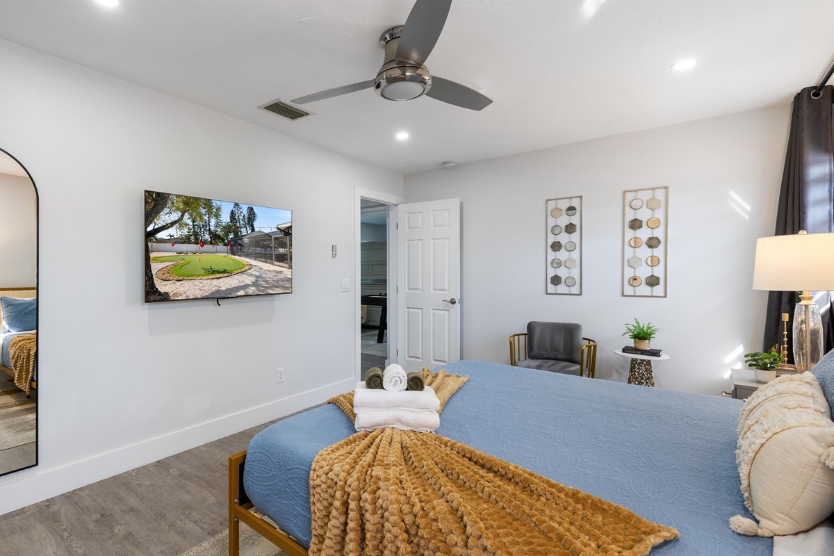 Master Bedroom with a king-size bed, an ensuite bathroom, and a mounted TV.