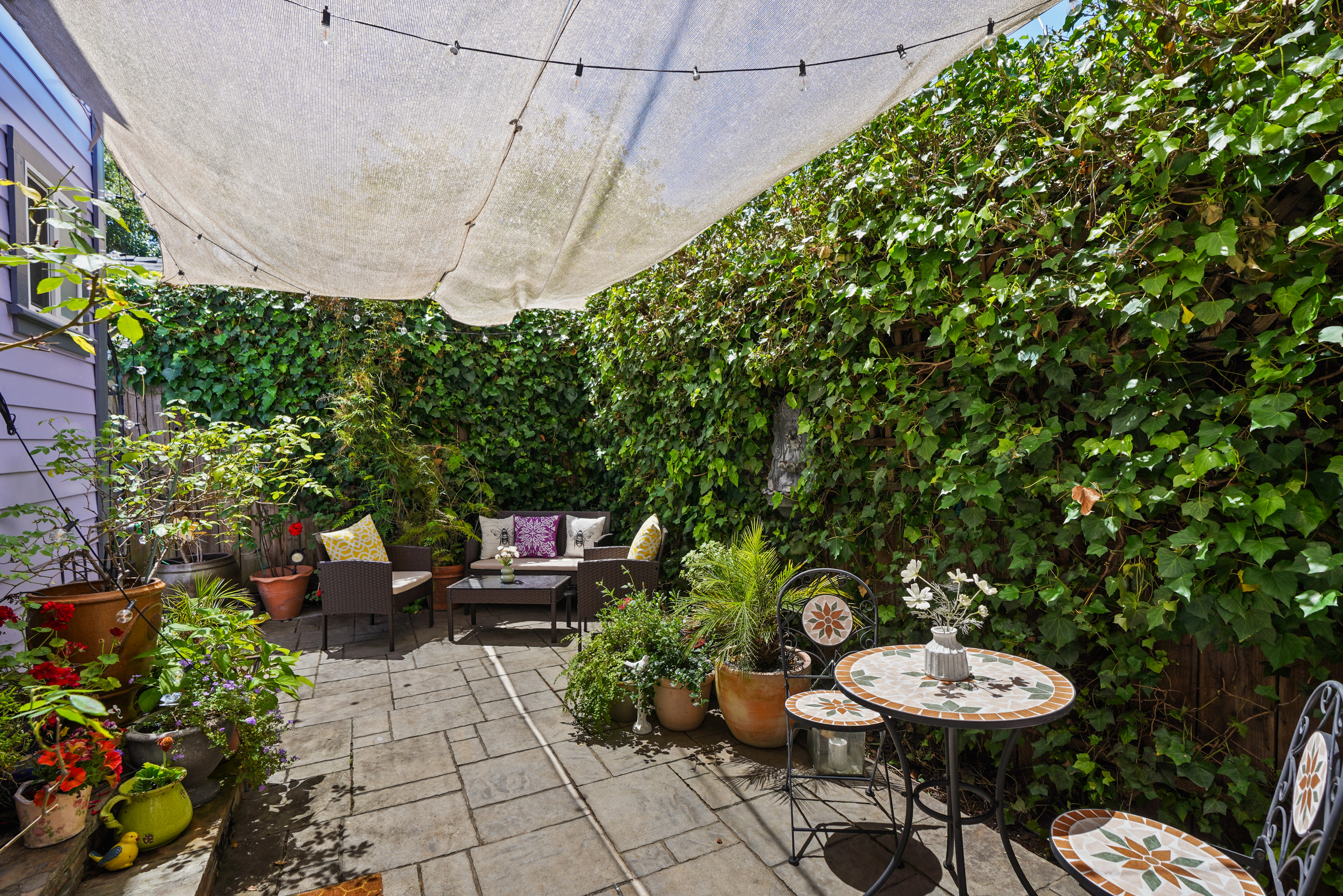 Small but cozy backyard filled with flowers — a quiet spot to unwind after wine tasting or exploring downtown Napa.