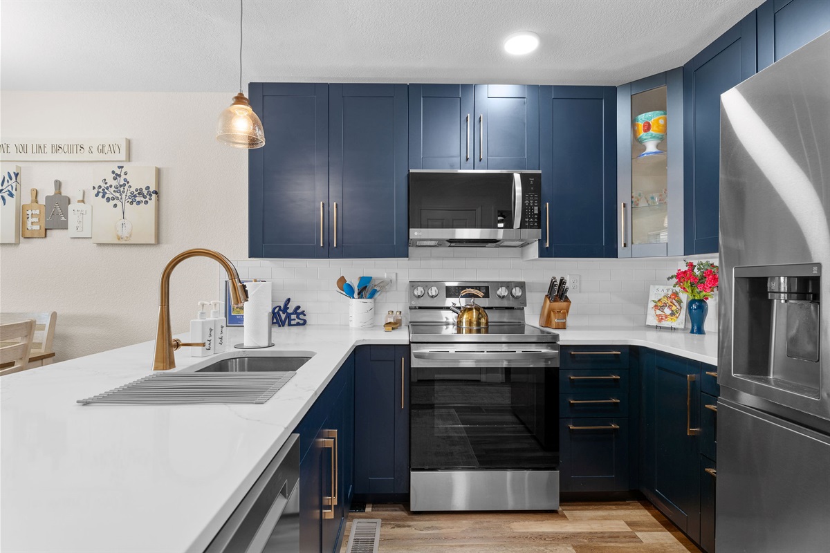 Stylish kitchen with navy cabinets and modern finishes.