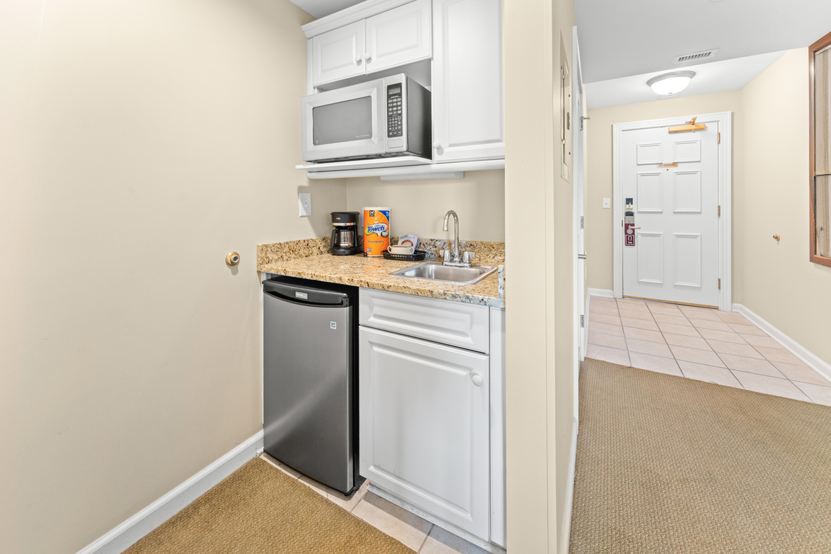 Kitchenette, coffee machine, sink and mini fridge