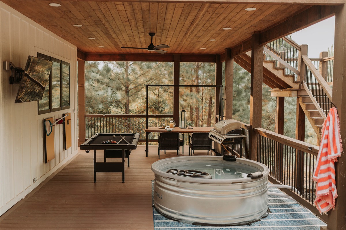 Private Resort-style covered patio, lower-level deck designed for couples: grill dinner, shoot pool, watch TV and unwind in the cocktail pool with nothing but miles of forest around you.