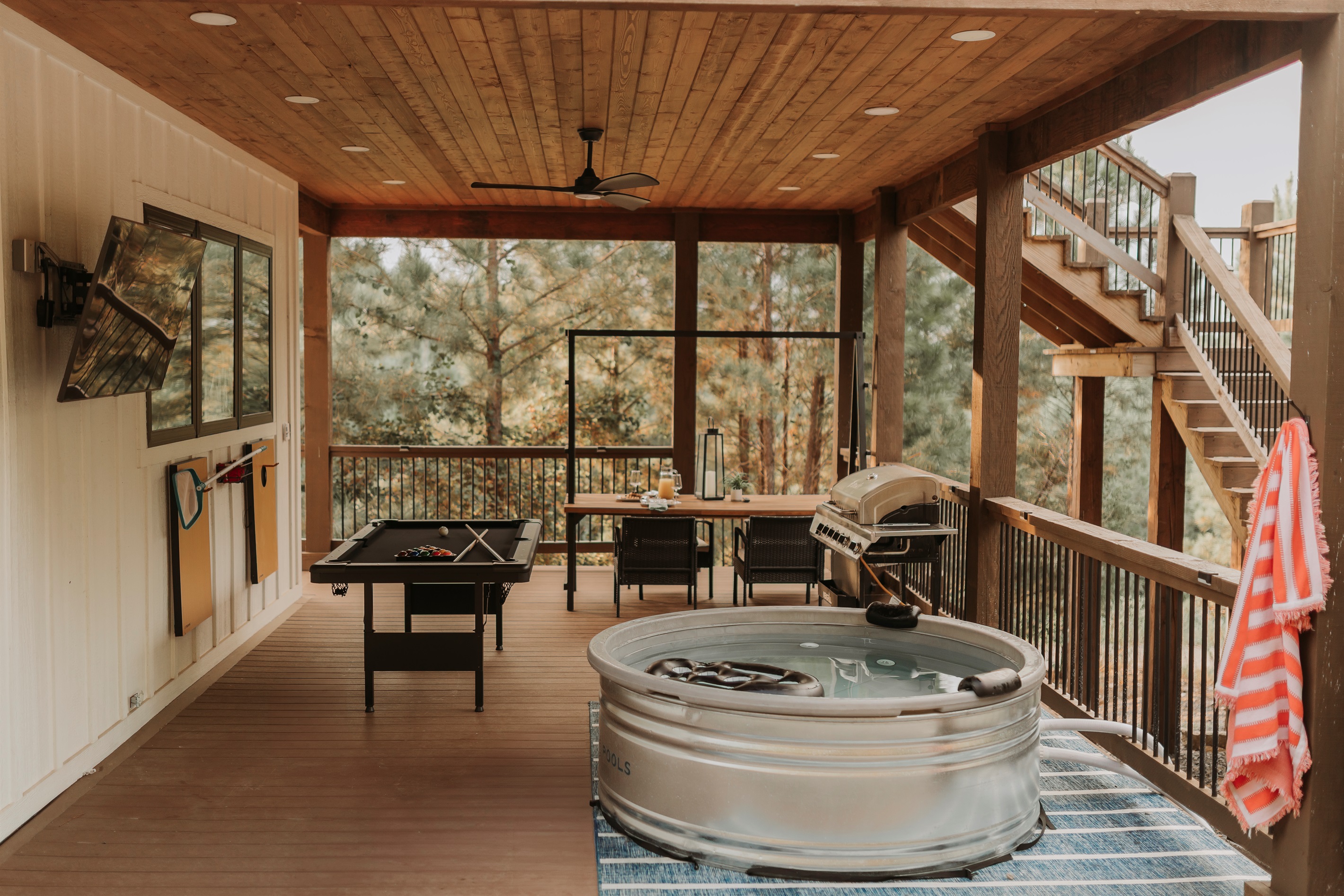 Private Resort-style covered patio, lower-level deck designed for couples: grill dinner, shoot pool, watch TV and unwind in the cocktail pool with nothing but miles of forest around you.