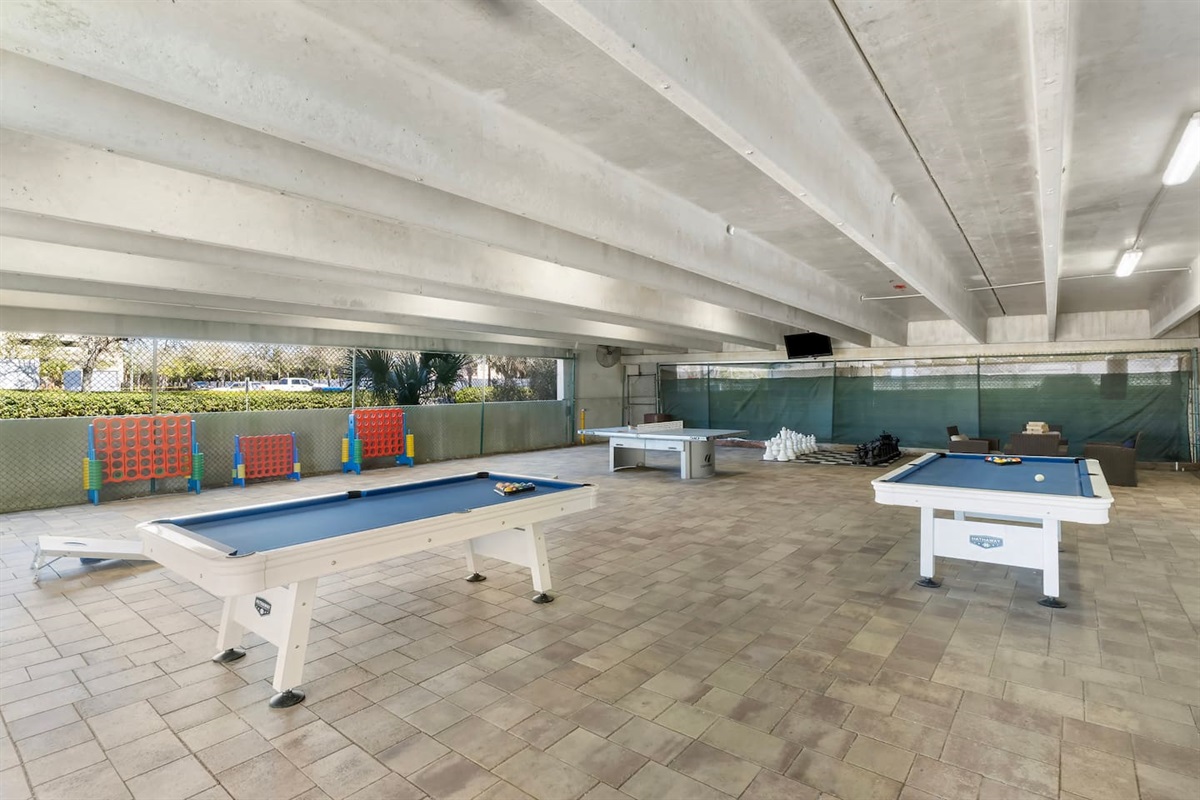 Rain or shine, there’s fun for everyone in the covered game area—featuring pool tables, ping pong, giant Connect 4, chess, and more! Perfect for family-friendly entertainment just steps from the condo.