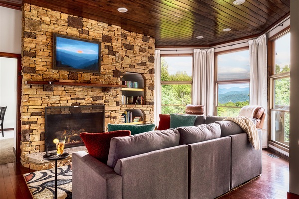 Cozy mountain view living room with stone fireplace — the heart of Ober Look Chalet.