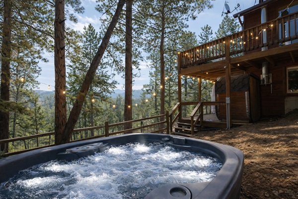 💦🌲 Private hot tub under the pines with string lights ✨—unwind with bubbling soaks, fresh mountain air, and peaceful forest views 🌄