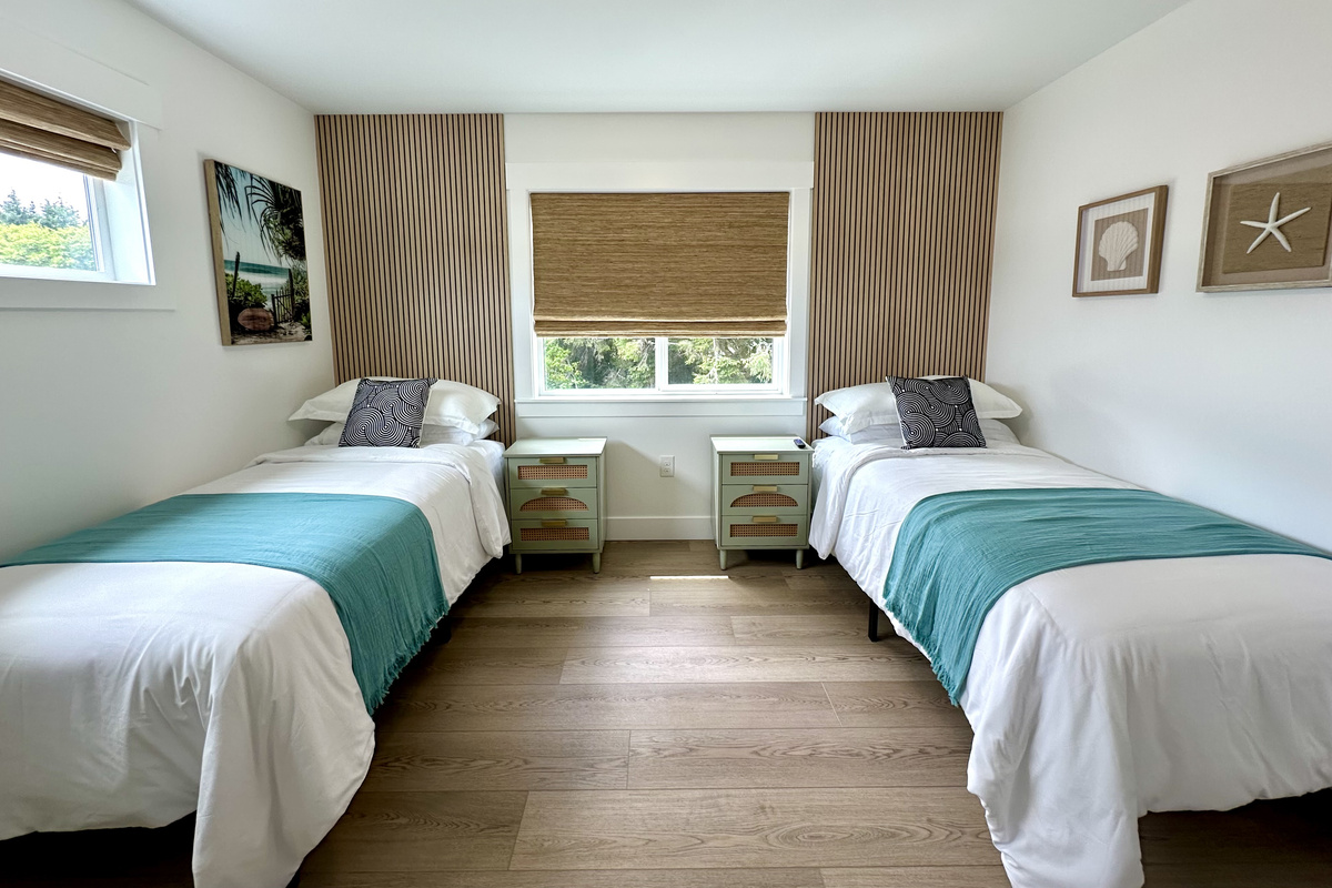 Two Twin XLs that push together into a king; linens for both setups are waiting in the closet.